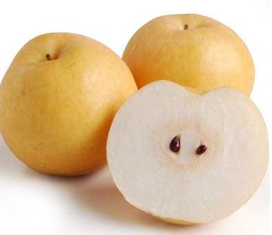 3 whole Korean pears and 1 half pear cut open facing the camera with seeds showing