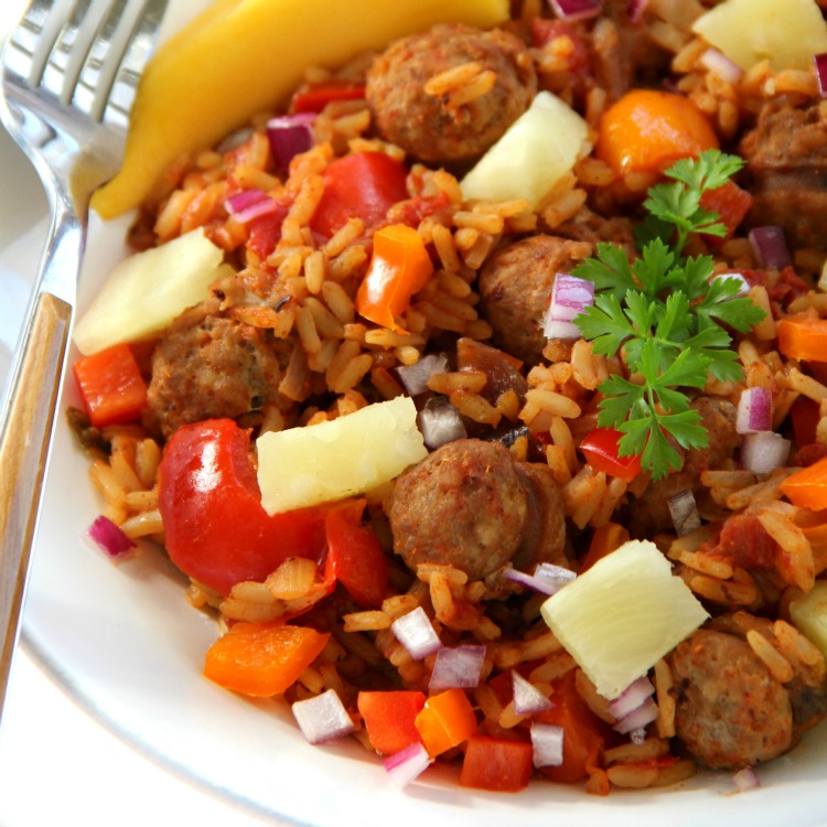 Hawaiian Jambalaya in a white bowl with a fork resting on the side