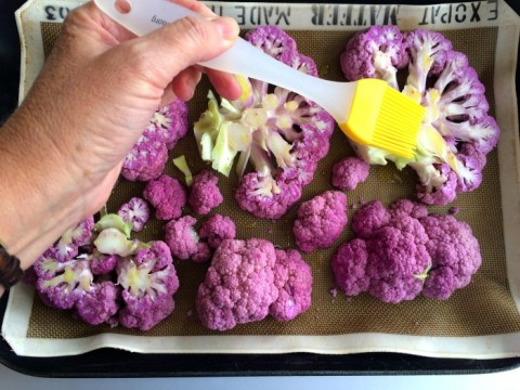 Brush or drizzle olive oil on the Purple Cauliflower Steaks on ShockinglyDelicious.com