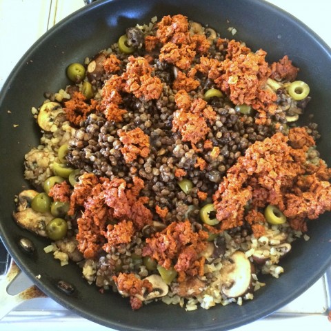 Chorizo, lentil and olives go into the skillet for Picadillo Stuffed Peppers on ShockinglyDelicious.com