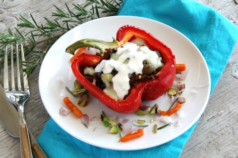 Soy chorizo takes the place of traditional beef in this delicious vegetarian Picadillo Stuffed Peppers with chorizo, lentils, cauliflower and mushrooms. A sweet-savory garnish includes dried apricots, pistachios, rosemary and a drizzle of crema. | ShockinglyDelicious.com