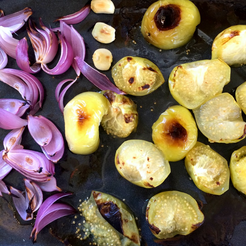 Onions garlic and tomatillos broiled and ready for salsa on ShockinglyDelicious.com