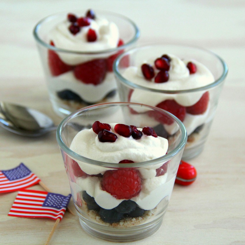 3 Red White and Blue Parfaits in small glasses, with tiny U.S.A. flags alongside