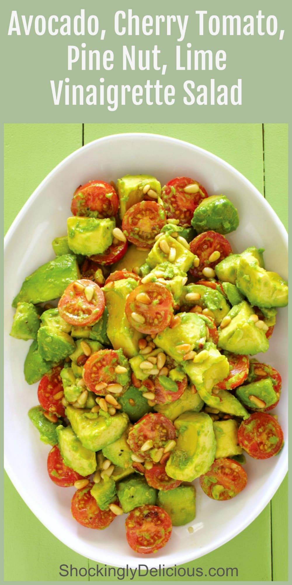 Avocado Cherry Tomato Salad on a large white platter on a greeen background