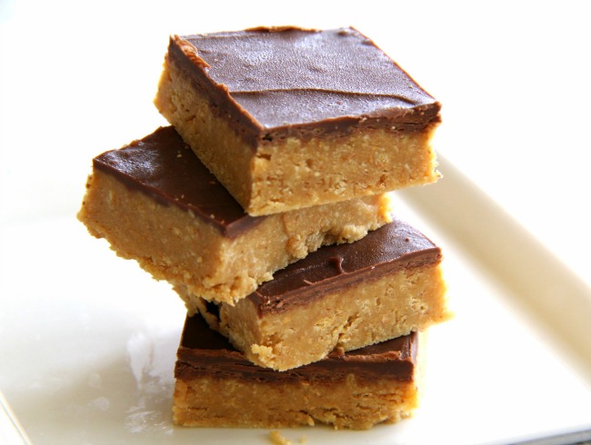 Who can say no to a peanut butter graham cracker crust bottom topped with milk chocolate? Not me! This is Pat Prager's recipe for Peanut Butter Bars from the fictional “Kitchens of the Great Midwest.” The recipe won Pat 6 blue ribbons at the county fair. Blue Ribbon No-Bake Peanut Butter Bars for the win! 