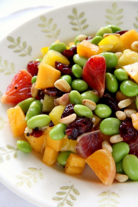 Colorful vegan, gluten-free salad with edamame, persimmon, peppers, pine nuts and blood orange. Recipe-on-shockinglydelicious-com