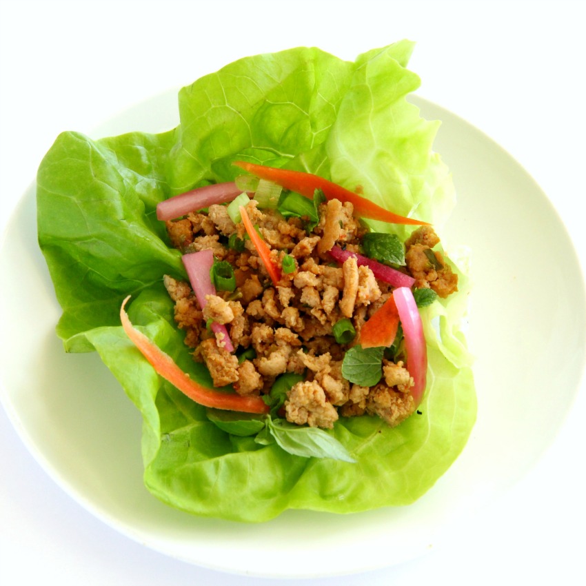 Thai lettuce wrap on a white plate on a white counter