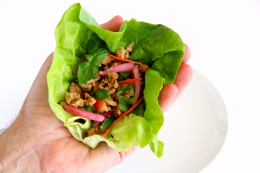 Thai Turkey Lettuce Wraps feature ground turkey flavored with fish sauce, soy sauce and lime juice, freshened with herbs and stuffed into a lettuce leaf for a low-carb meal.  Serve it as a rice bowl for a heartier dinner.