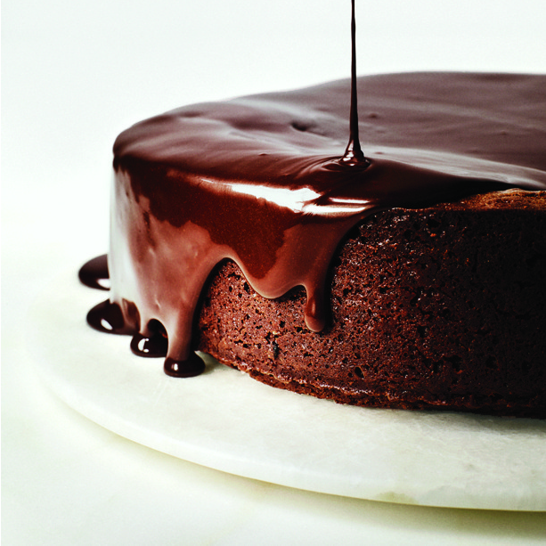 darkest-chocolate-cake-with-red-wine-glaze- on a white cake plate