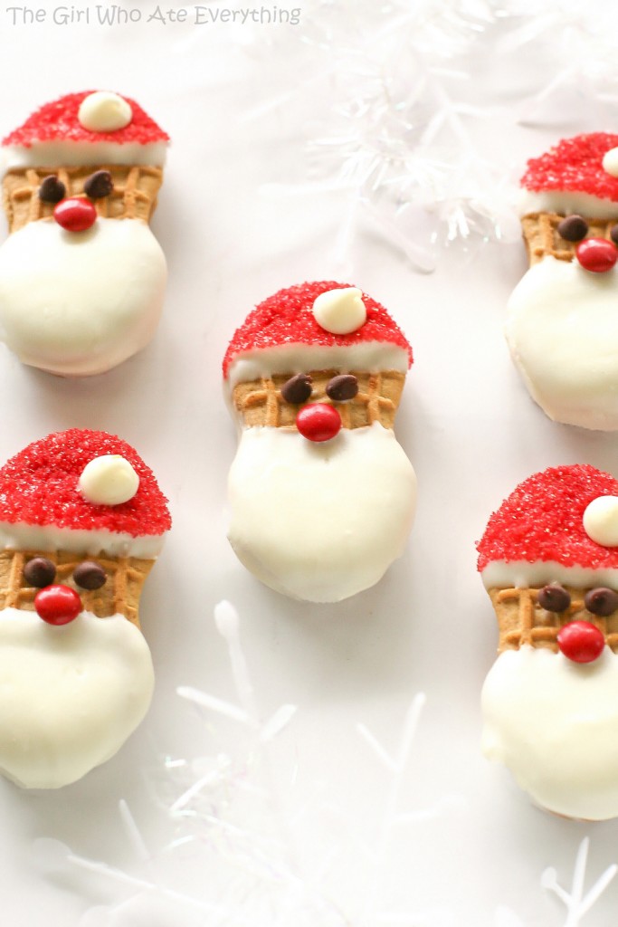 5 santa shaped cookies made from Nutter Butter cookies on a white background