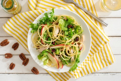 Brightly flavored chicken pasta lunch or dinner is lightened with apple and arugula, for a gluten-free Apple and Arugula Pasta with Chicken. Cranberries and toasted pecans decorate the top, on ShockinglyDelicious.com..