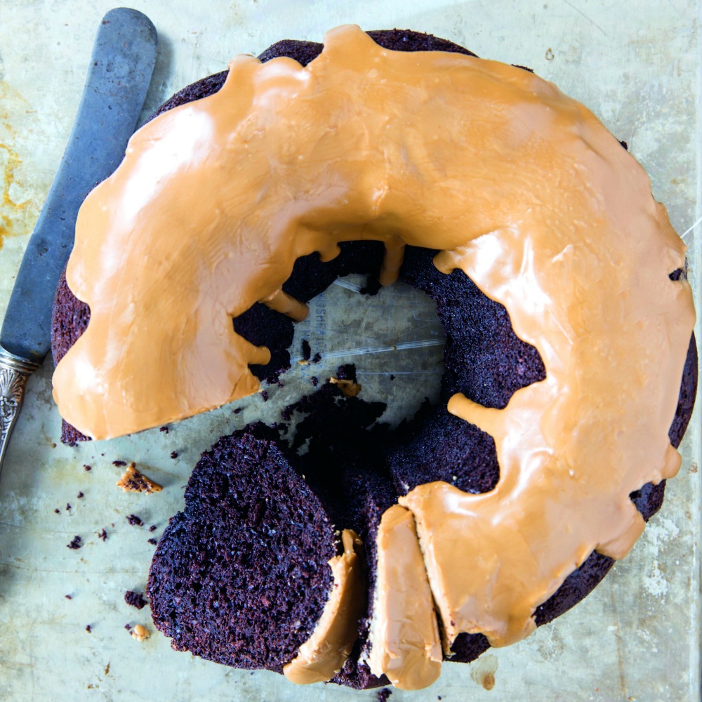 Aerial view of Fudgy Chocolate Bundt Cake with Coffee Glaze with a piece cut out