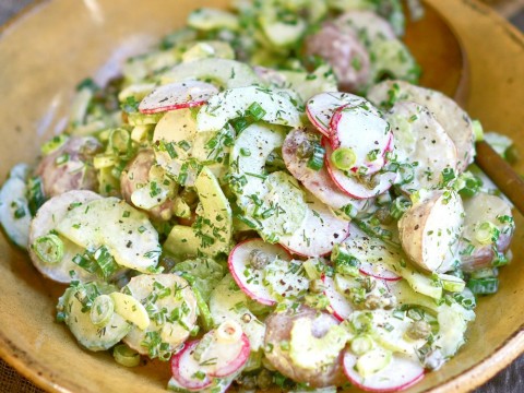 Russian Potato Salad, with crunchy radishes and celery, aromatic scallions, capers, dill and chives, draped in an umami dressing of anchovy, garlic, Worcestershire and lemon juice, is a wondrous balance of taste, color, temperature and texture.