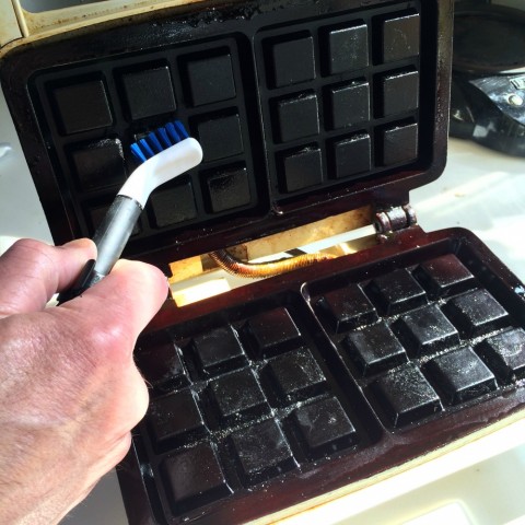 Kitchen Appliance Cleaning Set being used on a waffle iron