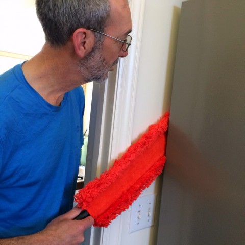 Microfiber Under Appliance Duster being used behind the refrigerator