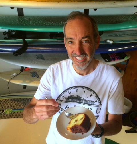 Surfer eating Cinnamon Walnut Coffee Cake from Boston Coffee Cake