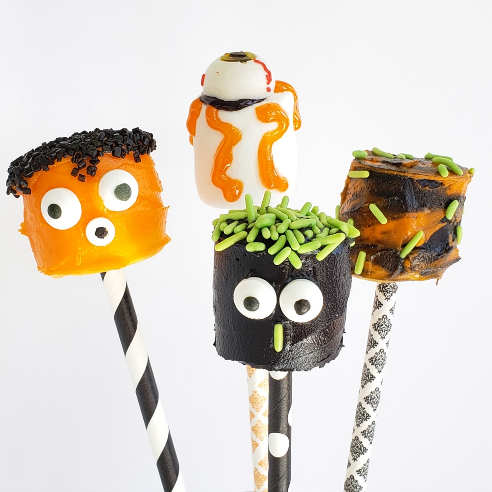 4 decorated Monster Marshmallows on Halloween straws on ShockinglyDelicious.com