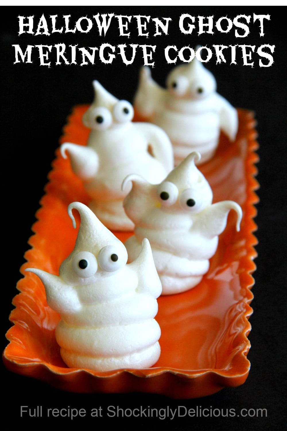 4 Halloween Ghost Meringue Cookies on an orange plate against a black background