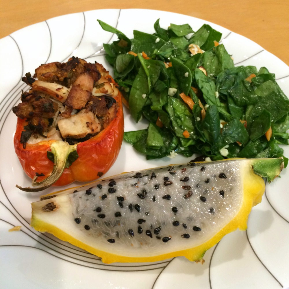 Stuffed Pepper on a dinner plate with Spinach Salad and Passionfruit for dinner