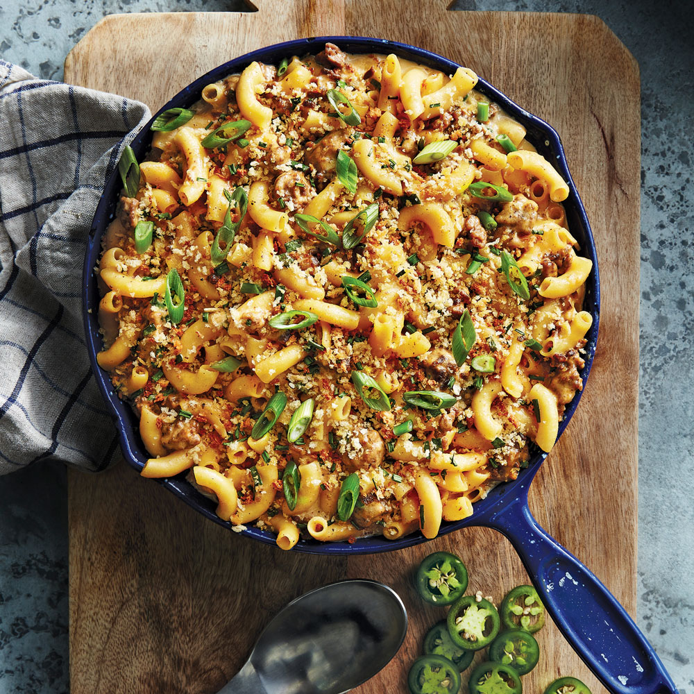 Blue skillet full of macaroni and meat set on a wooden board -- Hamburger-Helpa-from-Valeries-Home-Cooking 