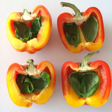 Enjoya Peppers cut in half with basil leaves inside