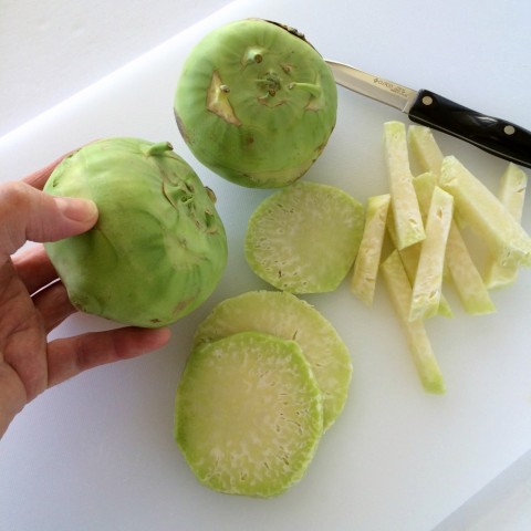 Kohlrabi being peeled and cut into matchsticks