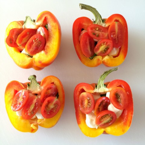 Striped Enjoya peppers cut in half with grape tomatoes inside