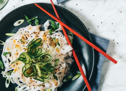 VEGAN COLD CUCUMBER-CHILE NOODLES: Chewy, wide rice noodles and refreshing, crunchy cucumber ribbons are dressed simply with sesame oil and chile oil. Throw on a few sesame seeds and green onions and you have a side dish that just might become your favorite thing. Ever.