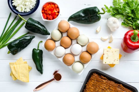 Ingredients for Overnight Mexican Breakfast Casserole laid out on a white background