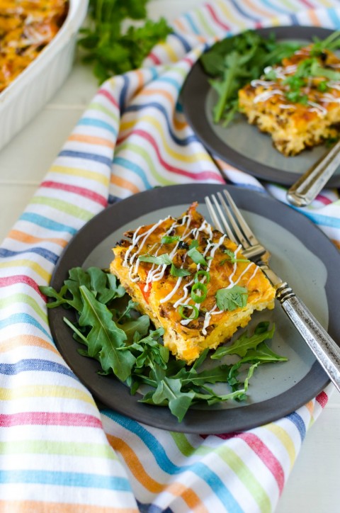 2 plates of Overnight Mexican Breakfast Casserole on a rainbow striped towel