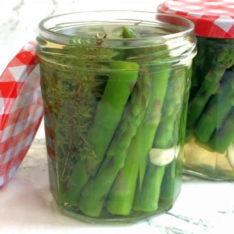 Refrigerator Pickled Asparagus in a jar with a red gingham lid on ShockinglyDelicious.com