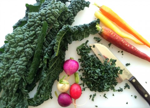 Chopping vegetables for Kale Salad with Apples, Carrots, Cheese and Capers