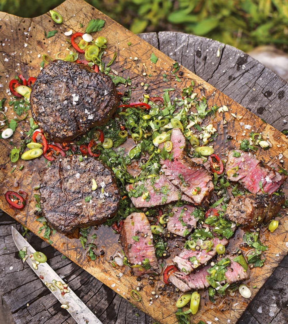 Filet Mignon with Cutting Board Sauce: The hot meat juices from the tender filet mignon steaks combine with the herbs and sauce ingredients right on the cutting board. As you cut the steak, it creates a sublime sauce.