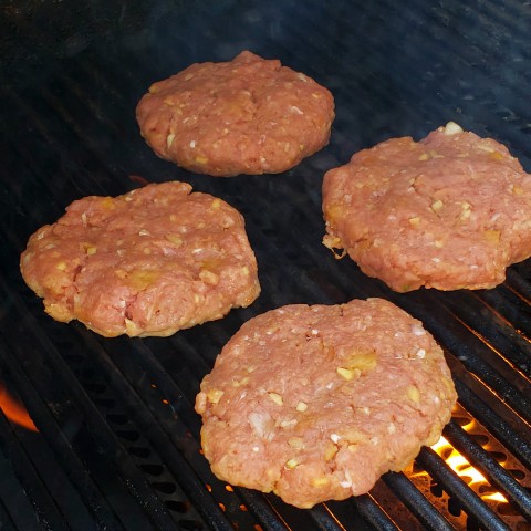 Island Pork Burgers on the grill on ShockinglyDelicious.com