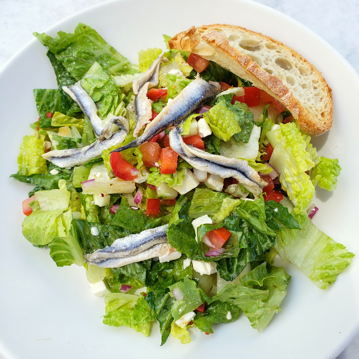 Mediterranean Salad with White Anchovies in a white bowl at The Sparrow Cafe in Malibu