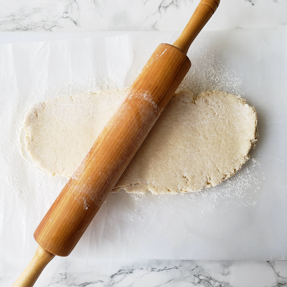 Rolling out Cream Cheese Pastry on a white board