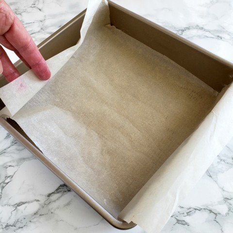 Butter the pan and line with parchment paper