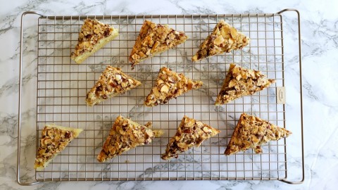 Swedish Visiting Cake Bars cut into triangles on an OXO cooling rack