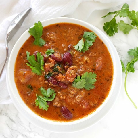 Bison Tortilla Soup in the Instant Pot, in a white bowl on marble counter