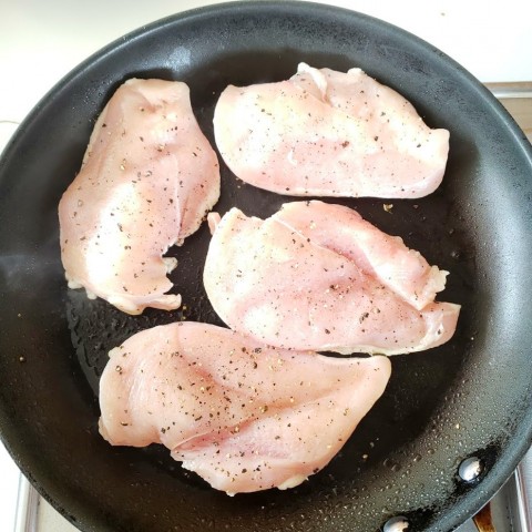 Chicken breasts in a skillet on ShockinglyDelicious.com