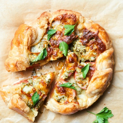 A Tomato Galette is a free form savory tomato tart that brings the best ripe tomatoes to rest on a crispy crust, blanketed by herby, melty cheese. Whether you want a kid-friendly dinner, a date-night entree or are trying to impress at a dinner party, this delicious tart fits the bill.