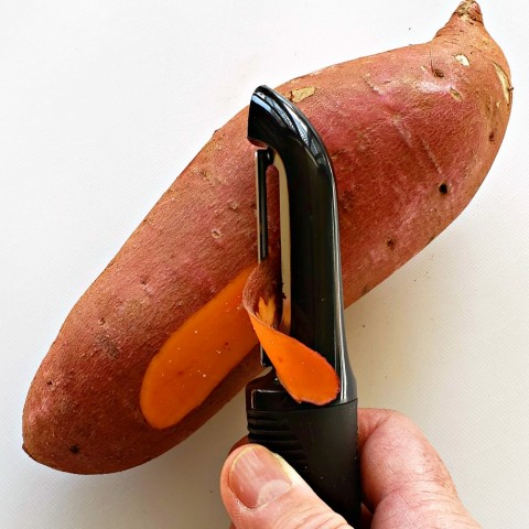 Peeling a sweet potato (yam) with an OXO peeler