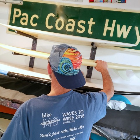 Sunset Surf hat on a surfer in the garage