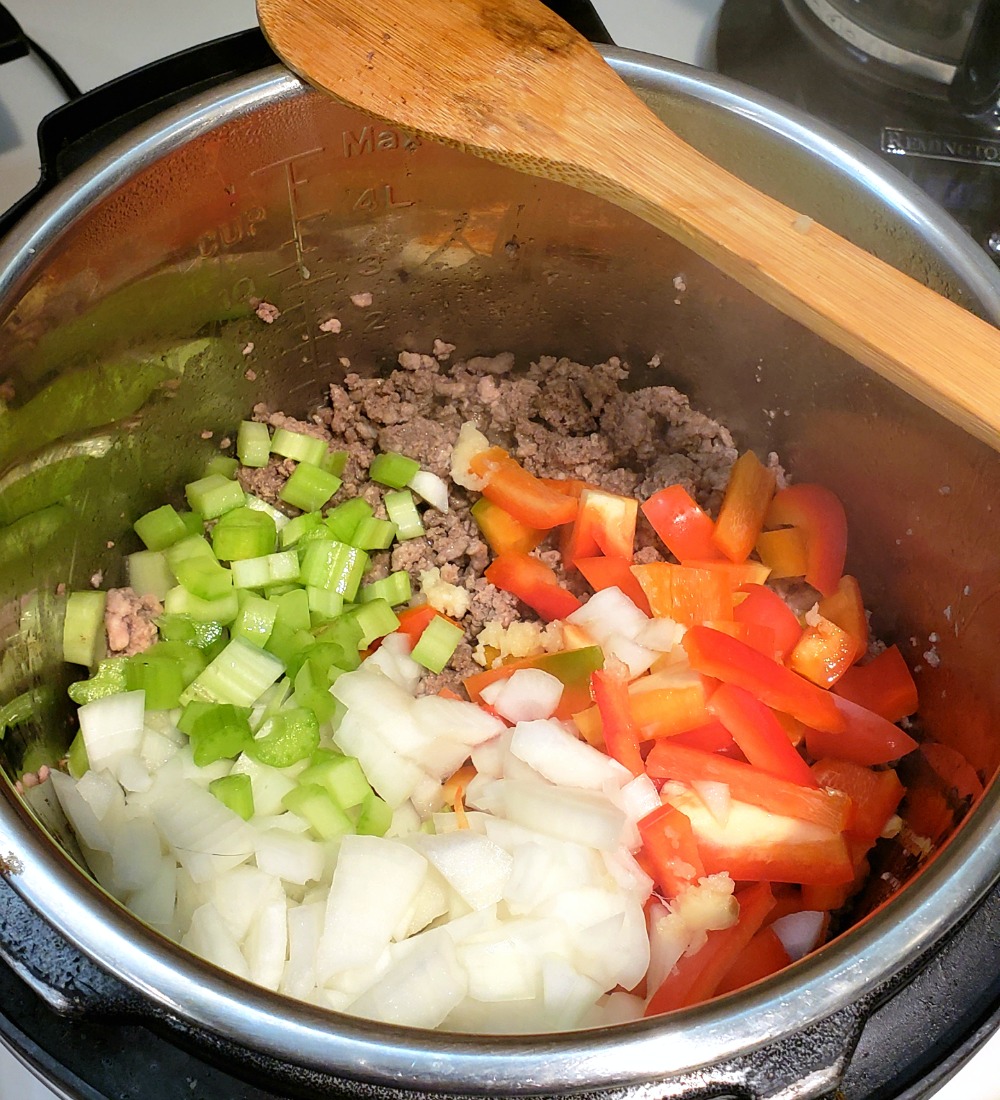 Onion, celery, red pepper and garlic in with the meats in the Instant Pot for Sloppy Joes