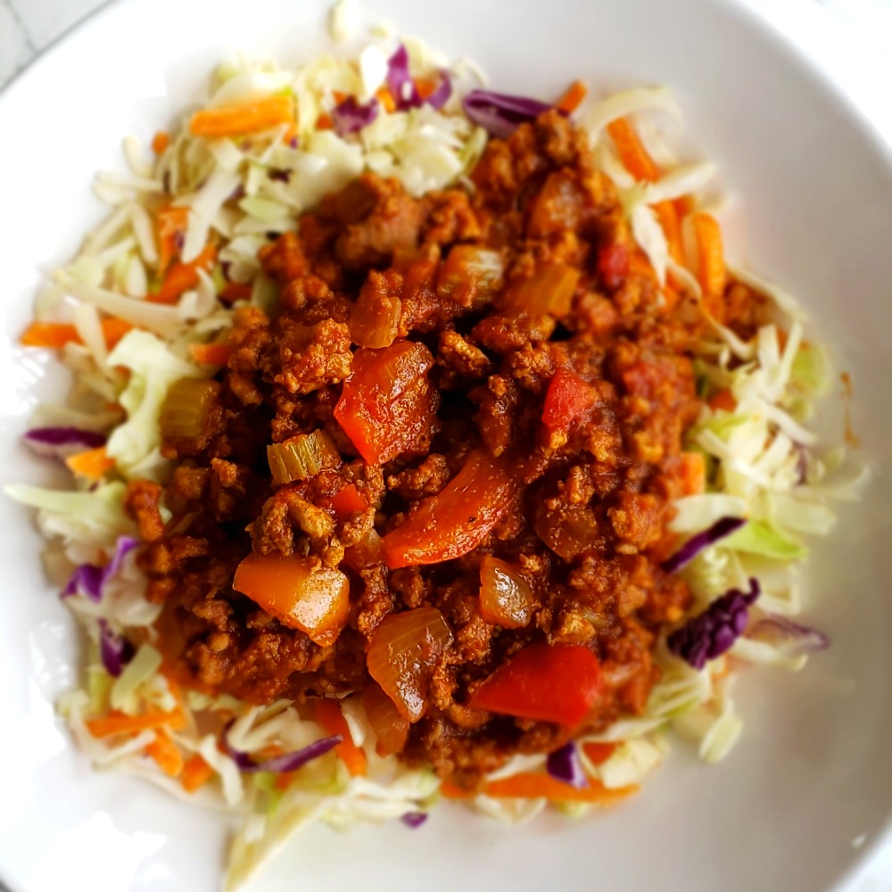 Instant Pot Sloppy Joes spooned on top of shredded cabbage on ShockinglyDelicious.com