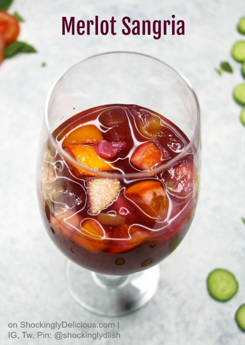 Glass of Merlot Sangria with fruit floating in it on ShockinglyDelicious.com