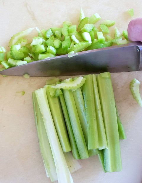 Chop celery for Hot Chicken Salad on ShockinglyDelicious.com