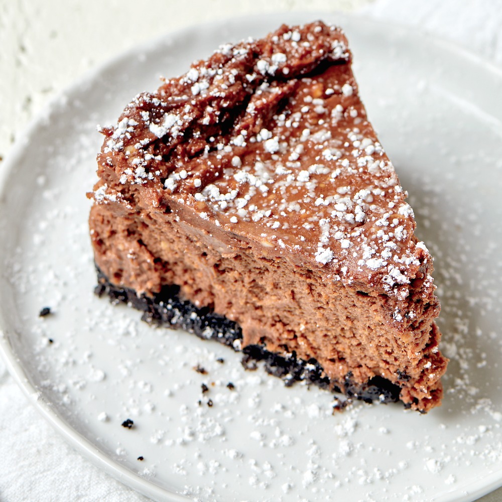 Wedge of Double Chocolate Fudge Cheesecake for the Instant Pot on a white plate