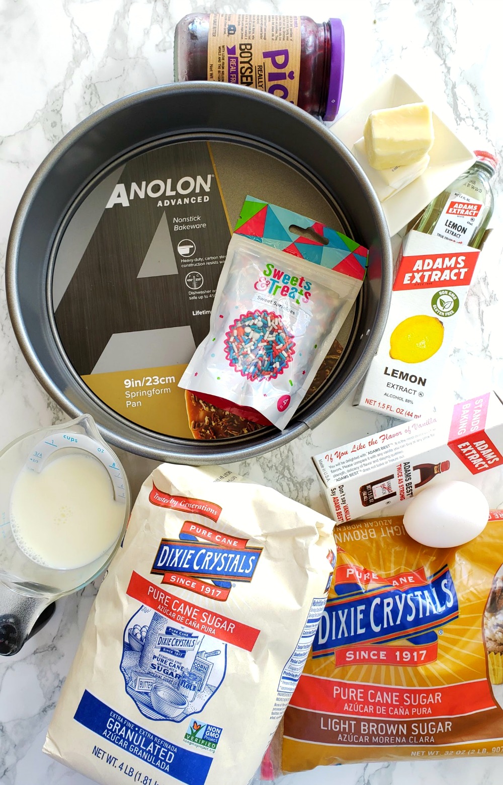 Ingredients for Jam Breakfast Cake with Streusel laid out on a white marble counter