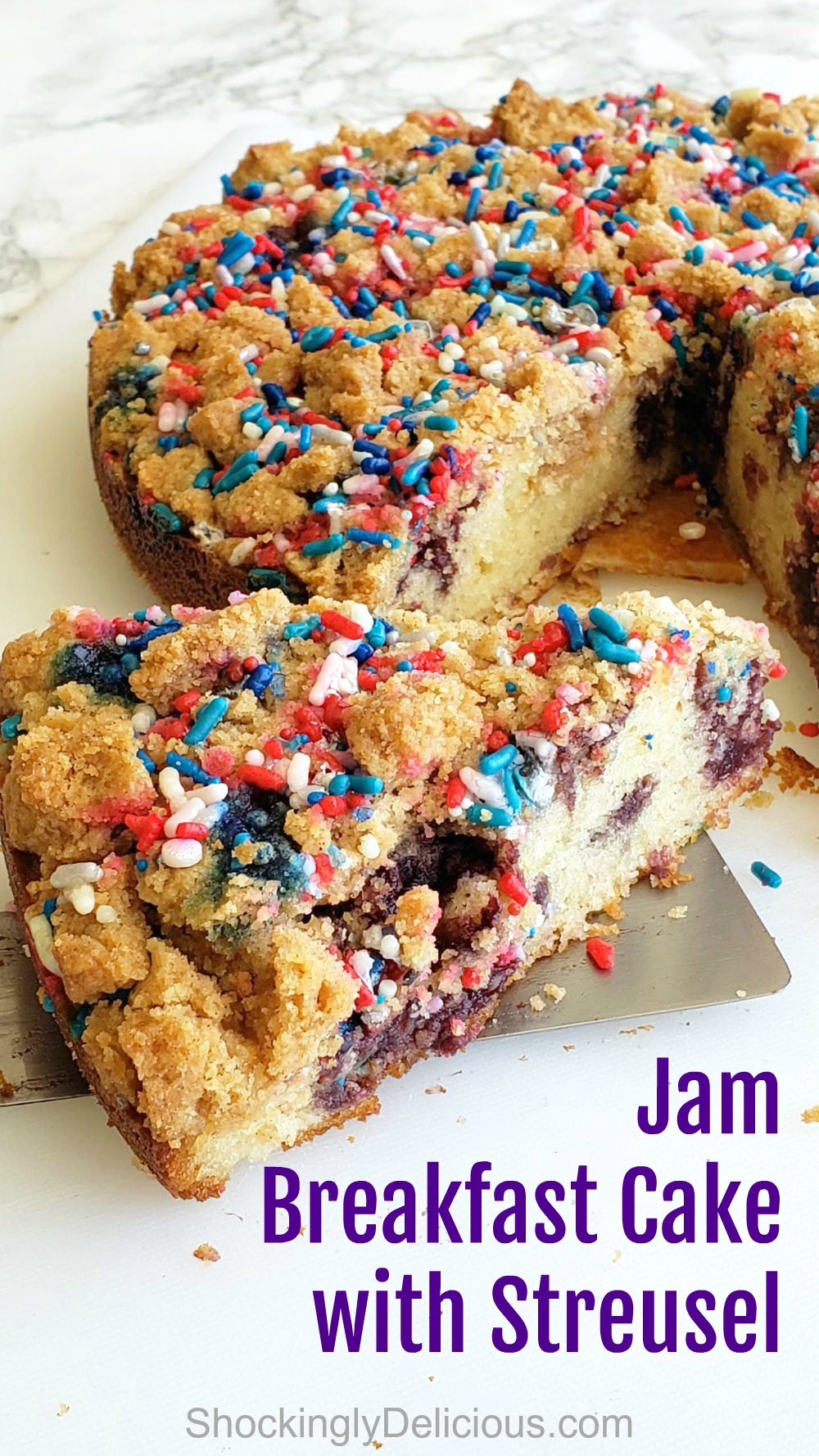 Spatula is removing a wedge of Jam Breakfast Cake with Streusel on ShockinglyDelicious.com